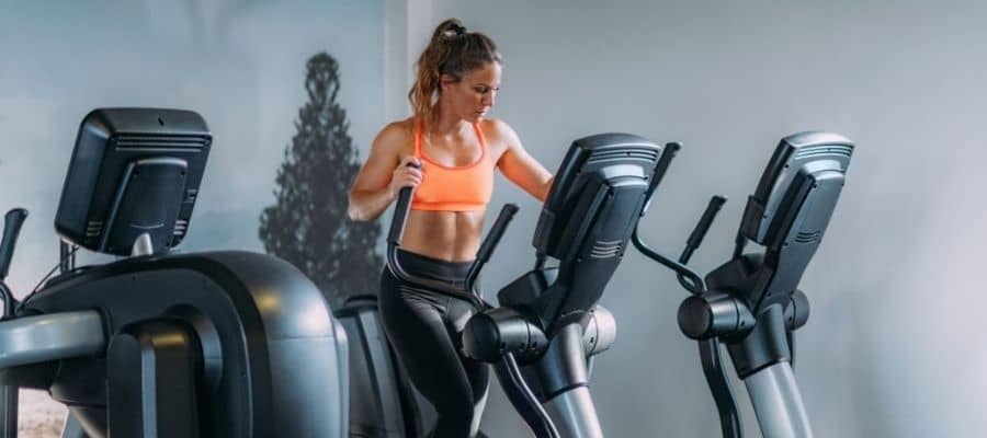 a woman burring calories on a a elliptical